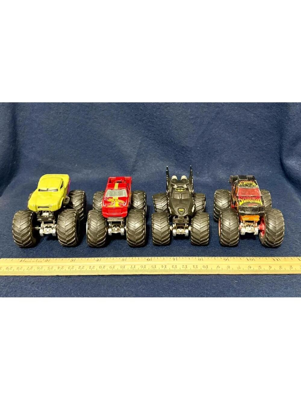 Mixed lot of 4 toy monster trucks